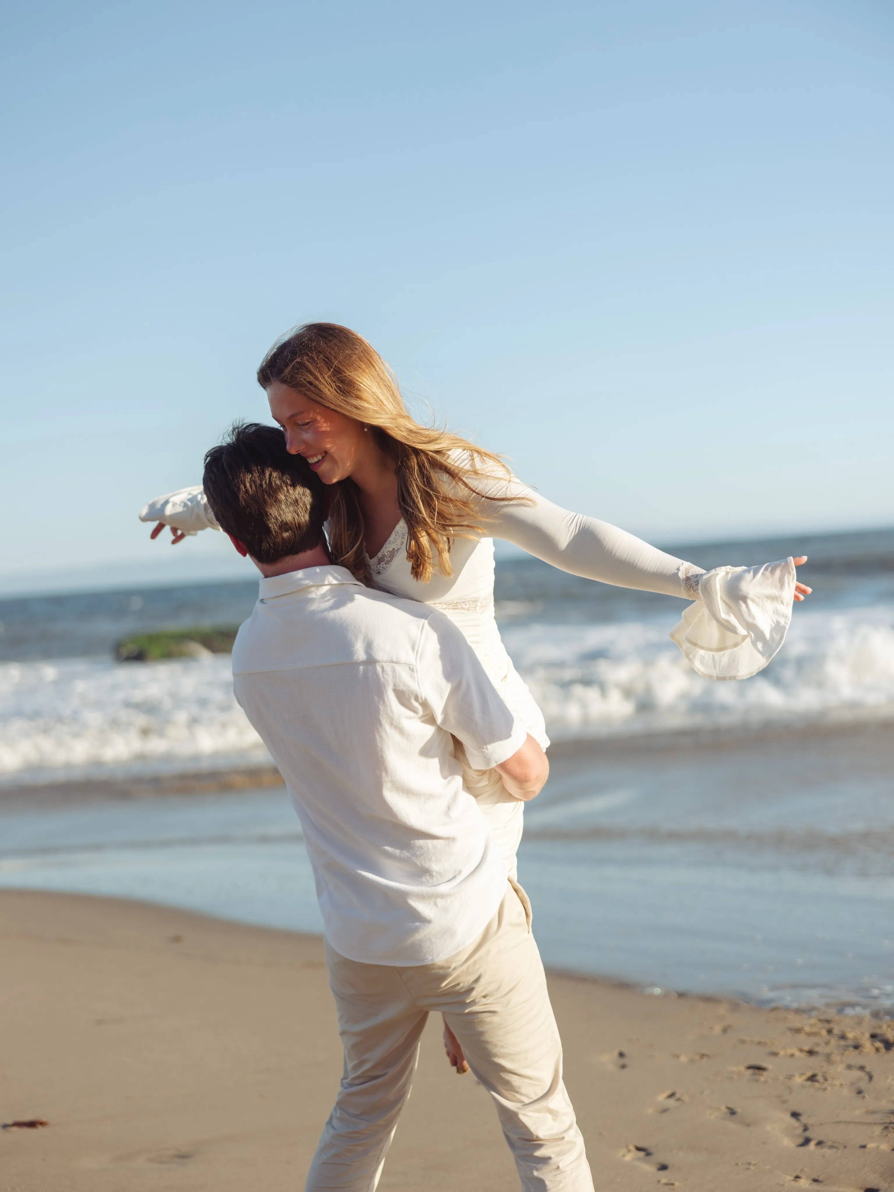 Couple spinning together on a Santa Barbara beach