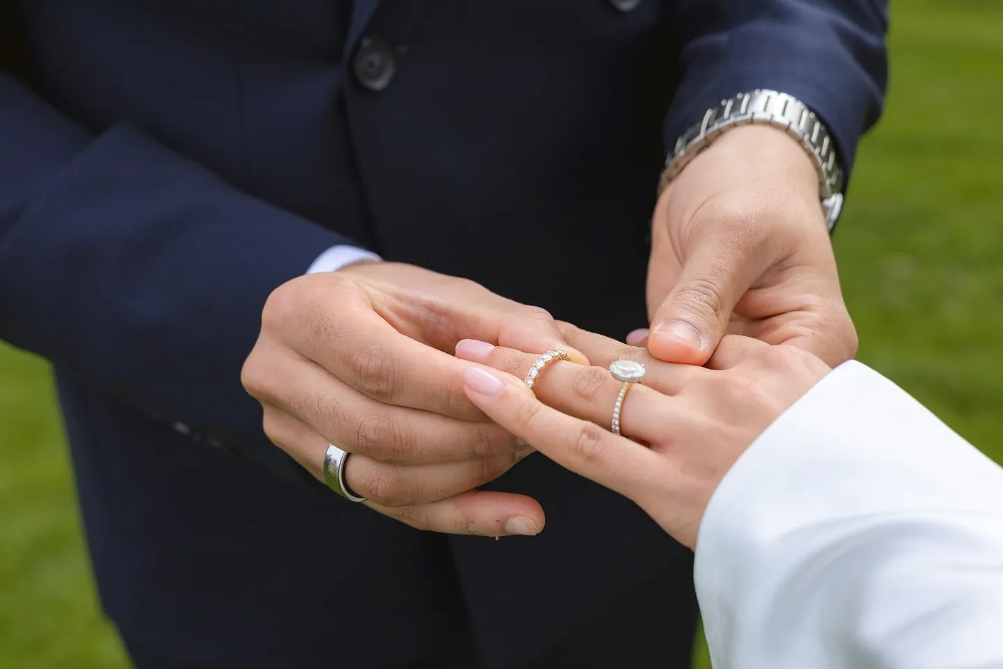 Close-up of the couple exchanging wedding rings
