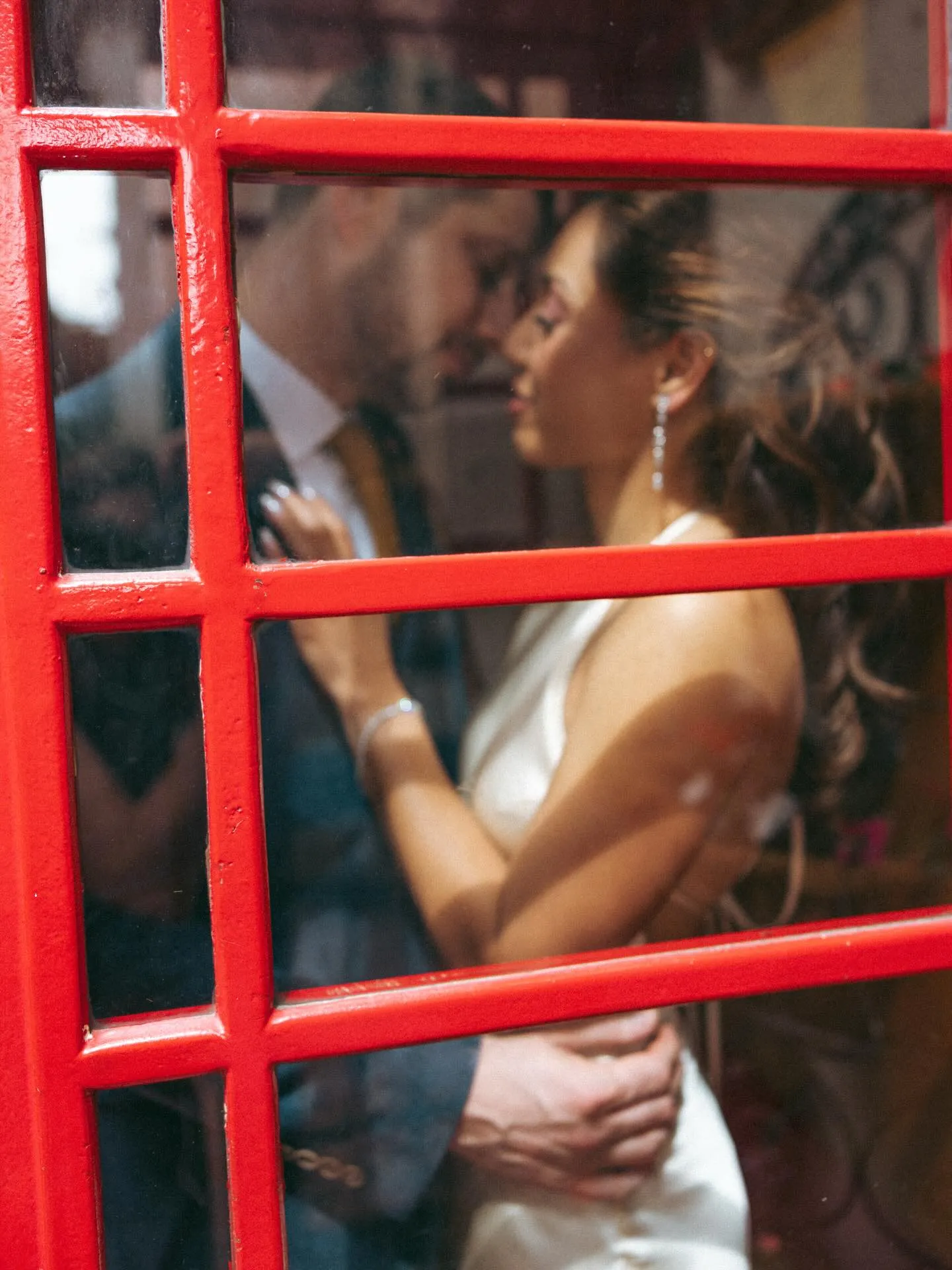 Couple embracing beside a red painted ladder